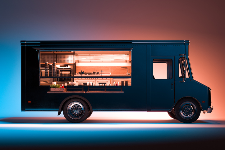 Side View of Black Food Truck With Detailed Interior Isolated on Illuminated Background. Takeaway food. 3d rendering.